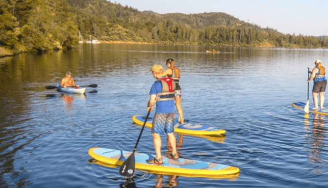 Photograph of locals paddle boarding on Shasta Lake.